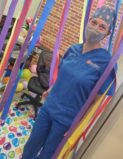 woman standing in birthday decorations
