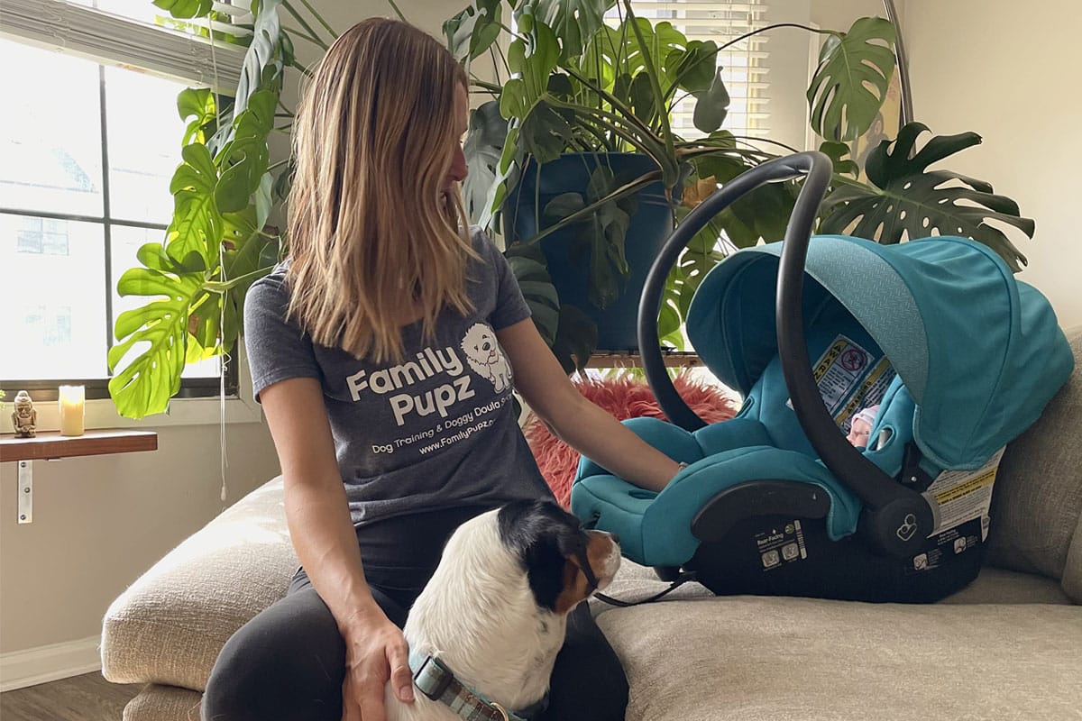 woman with a baby and a dog