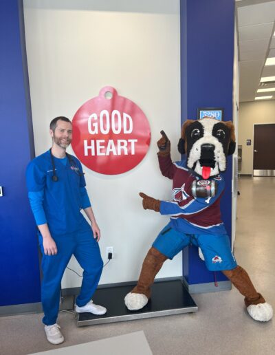 vet standing by a dog mascot